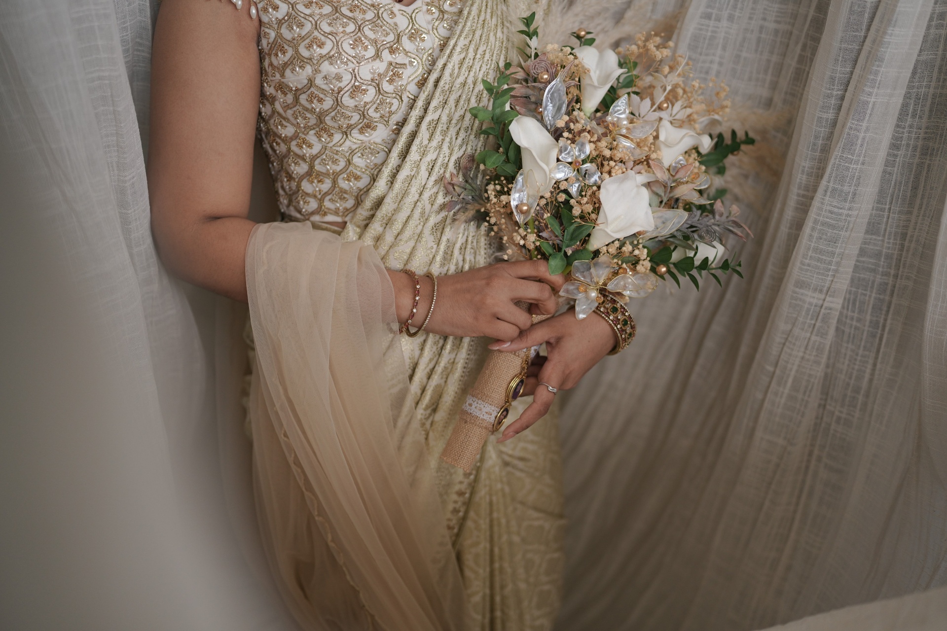 Detail of the bride's ivory saree and handcrafted bouquet