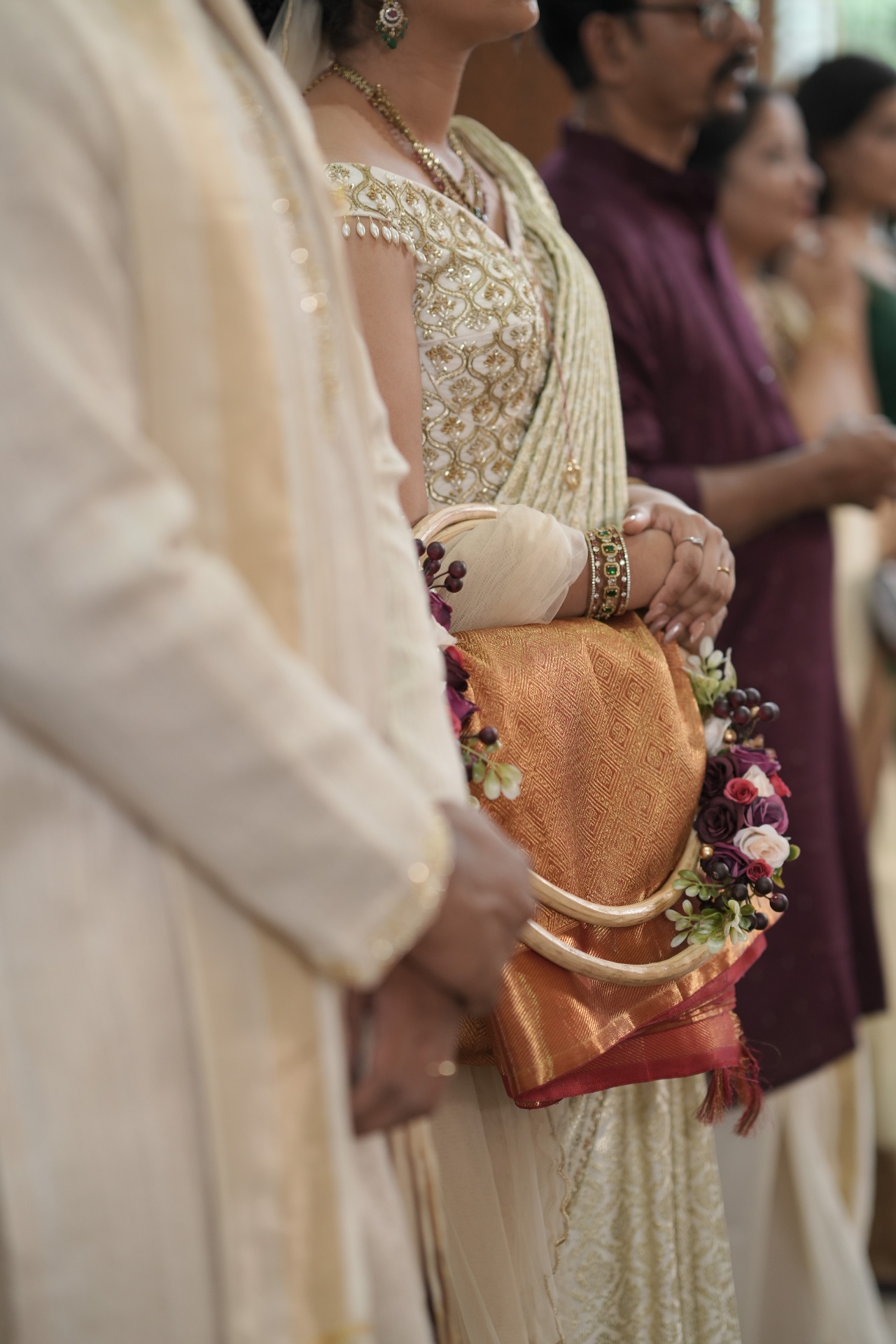 Detail of the manthrakodi saree in red, gold, and emerald tones