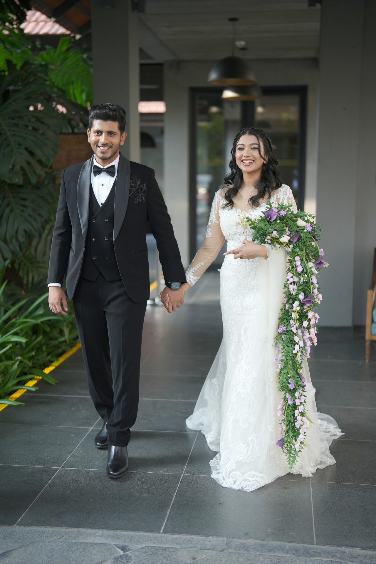 Alisha and Febin in white gown and black tuxedo at the ceremony entrance